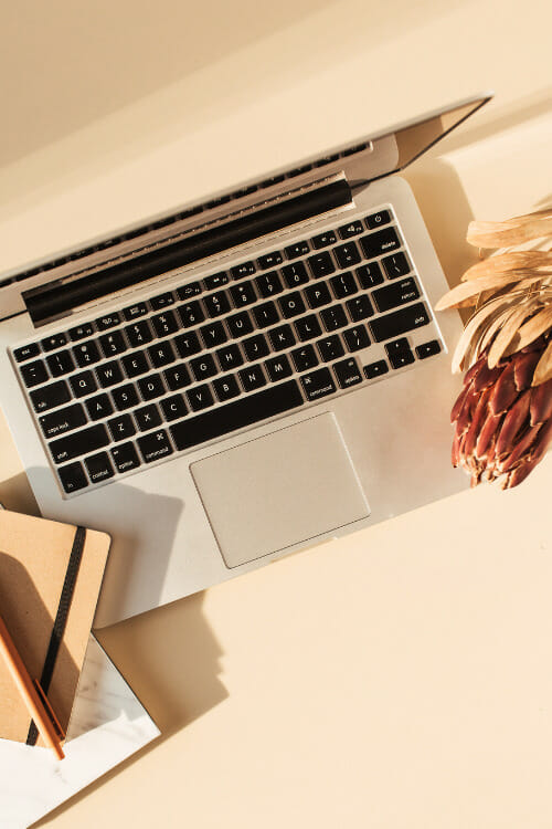 woman sitting at workspace writing about getting website conversions for business growth