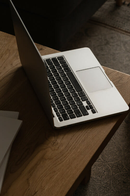 woman sitting at workspace writing about getting website conversions for business growth